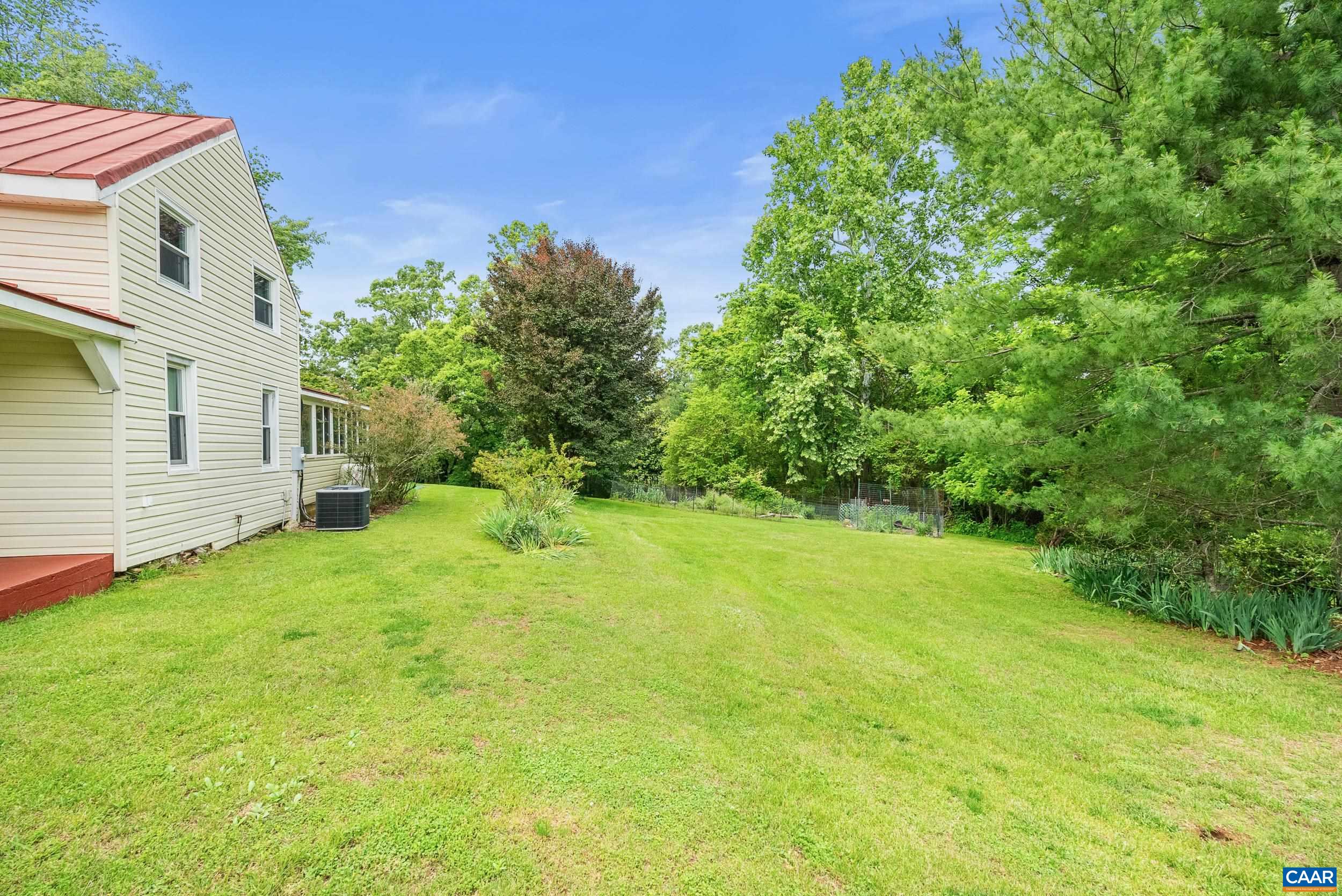 687 Gidsville Road Amherst, VA 24521 - Photo 46 of 70 a backyard of a house with plants and large tree