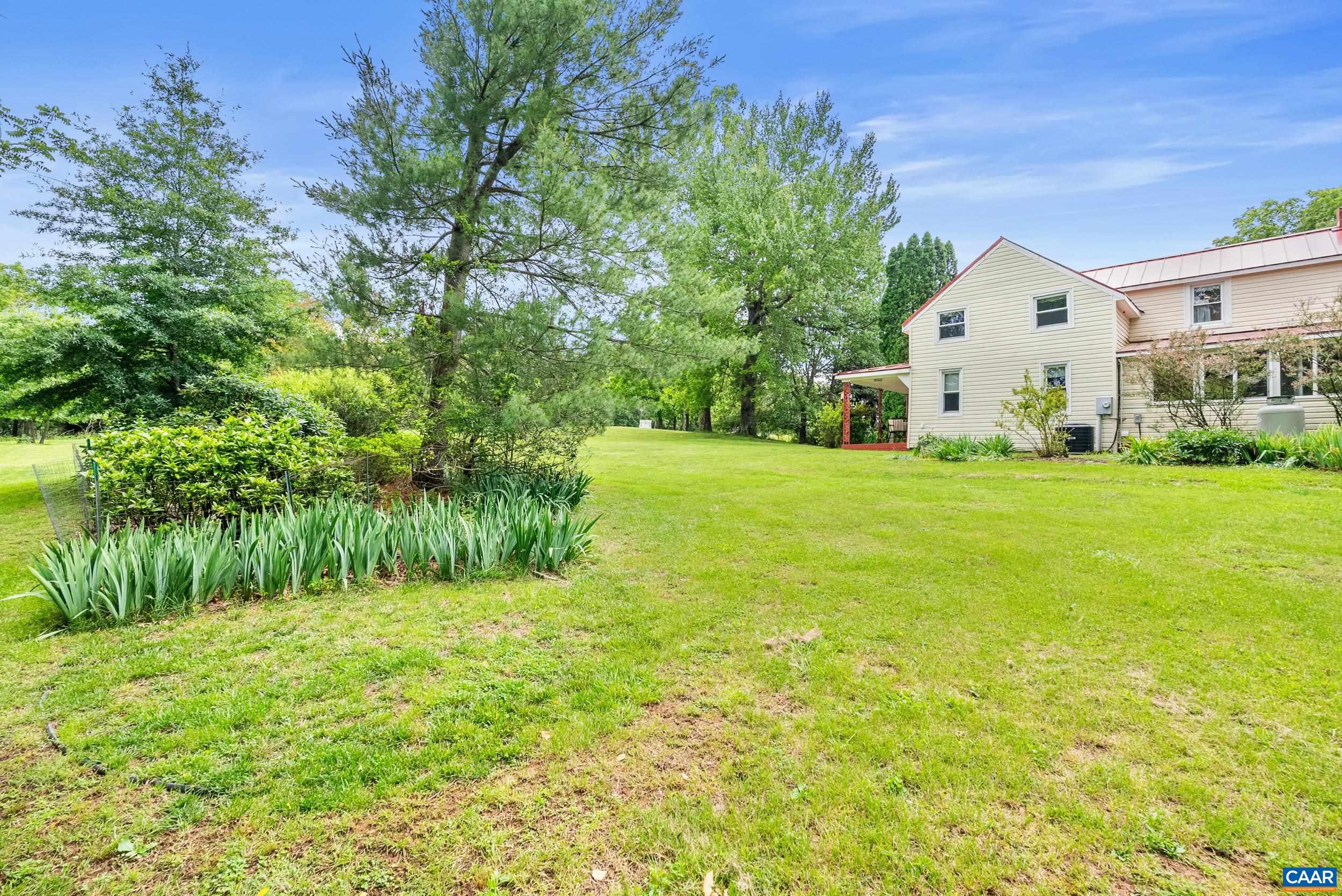 687 Gidsville Road Amherst, VA 24521 - Photo 47 of 70 a view of a white house with a big yard and large trees