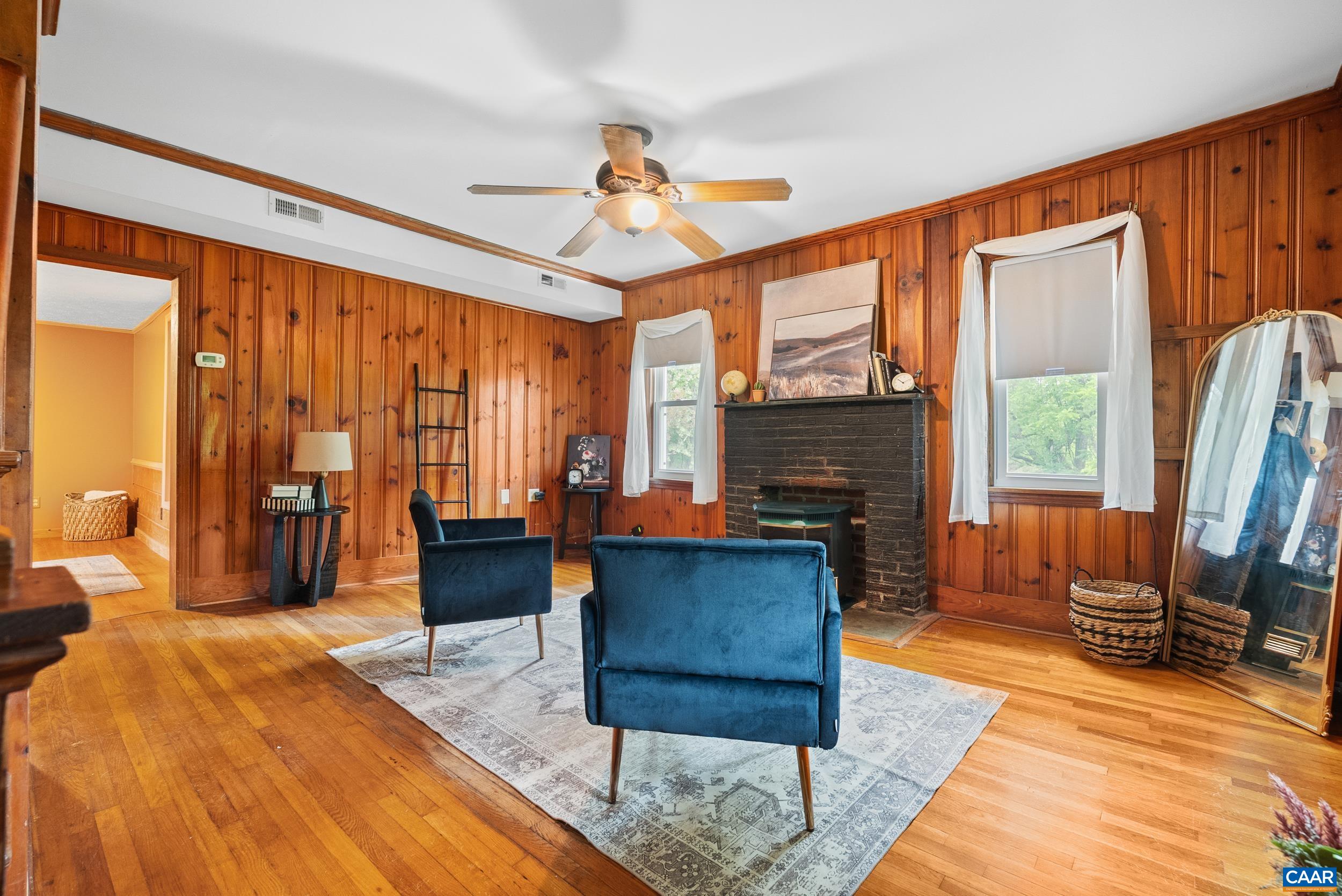 687 Gidsville Road Amherst, VA 24521 - Photo 9 of 70 a living room with furniture a fireplace and large windows