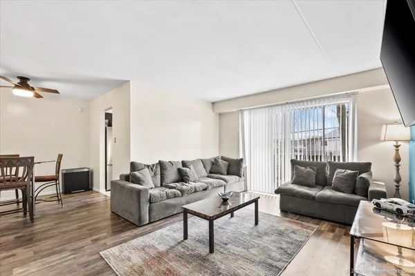 a living room with furniture and a wooden floor
