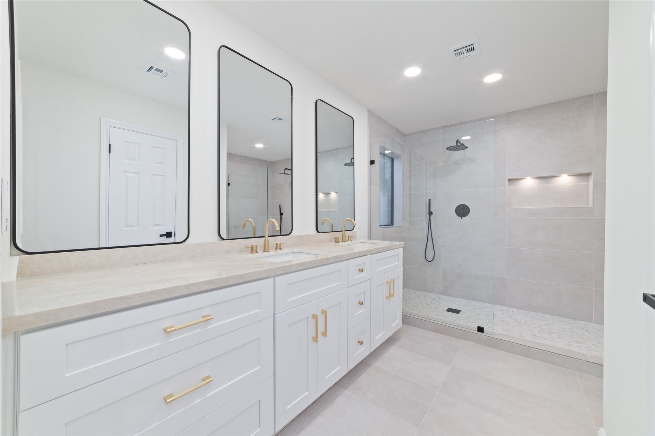 15651 Whitewater Lane Houston, TX 77079 - Photo 14 of 24 a bathroom with a double vanity sink and mirror