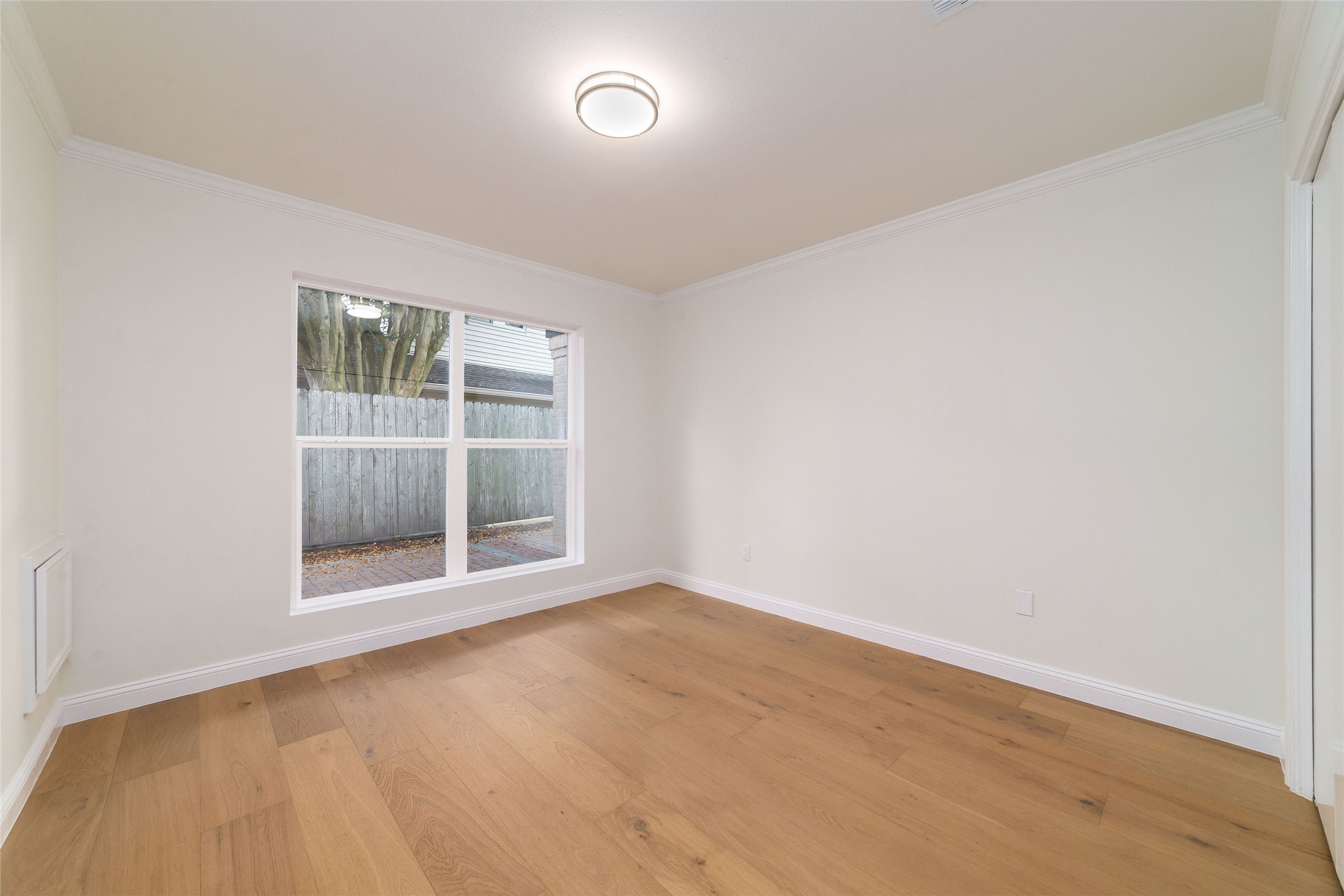 15651 Whitewater Lane Houston, TX 77079 - Photo 20 of 24 an empty room with a fireplace and windows