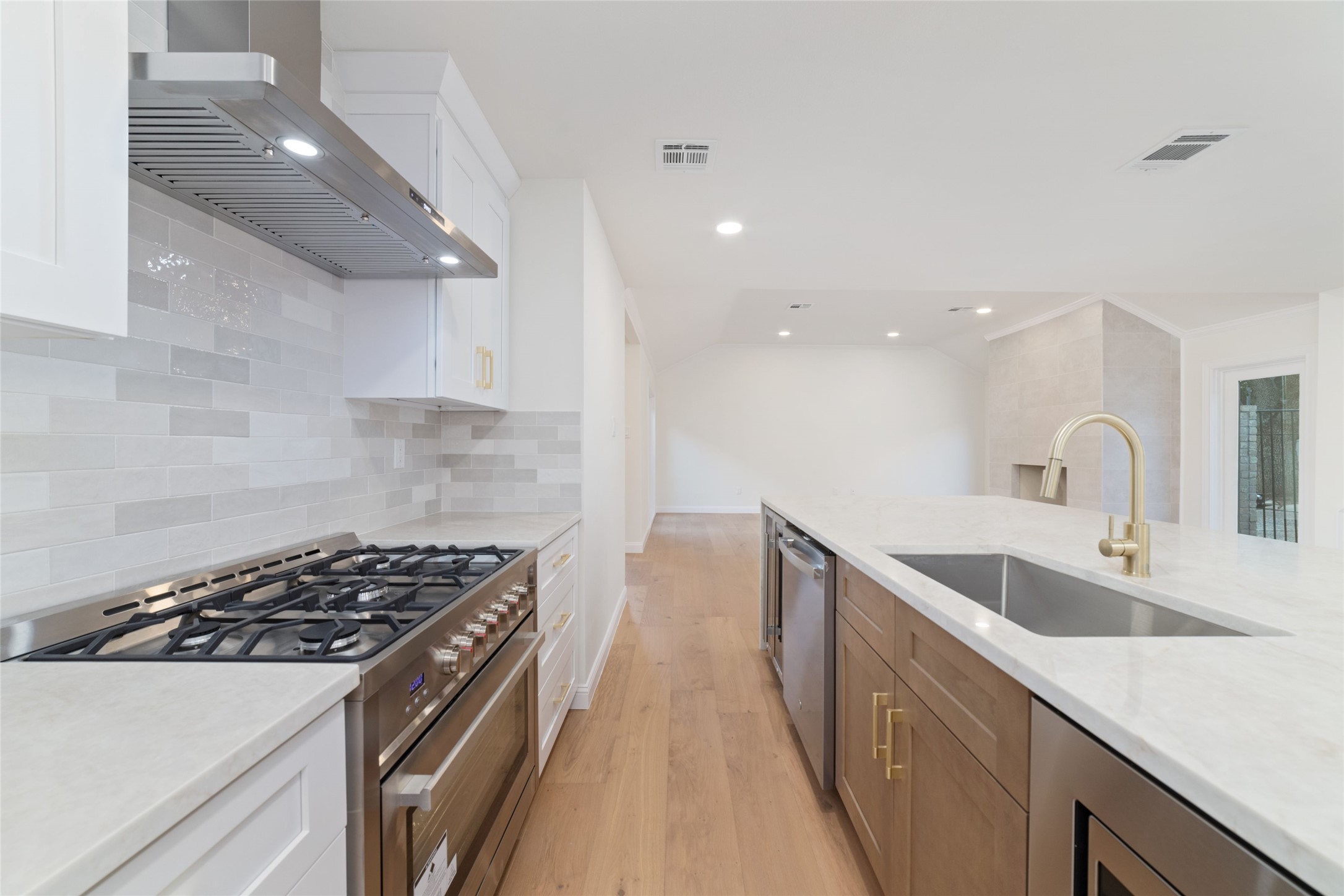 15651 Whitewater Lane Houston, TX 77079 - Photo 7 of 24 a kitchen with sink a stove and cabinets