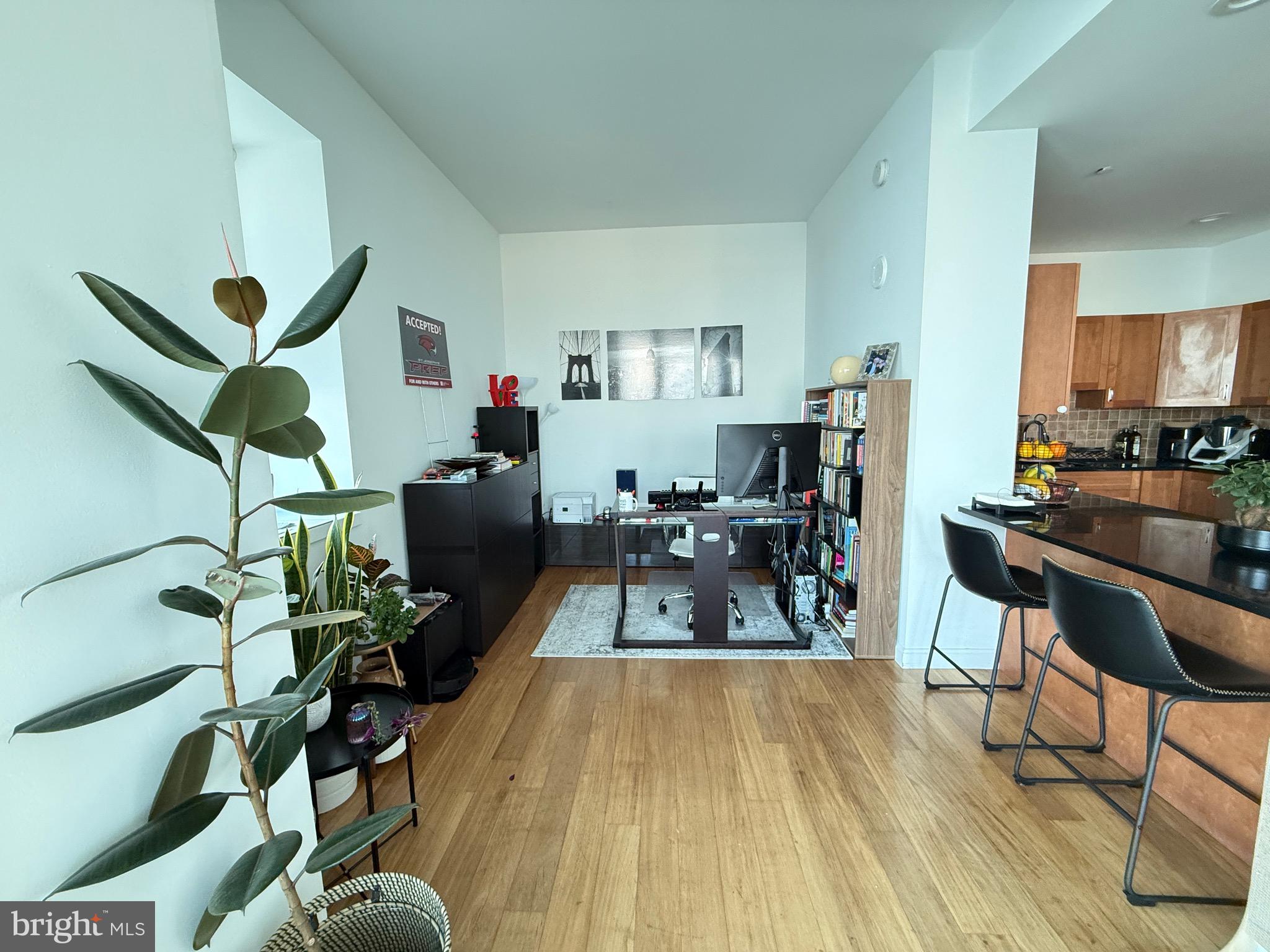 901 North Penn Street, Unit R2101 Philadelphia, PA 19123 - Photo 21 of 33 a view of a dining room with furniture a rug and wooden floor