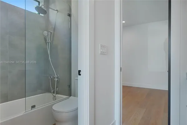 a bathroom with a shower and a toilet