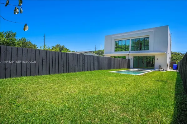 a view of house with backyard space and balcony