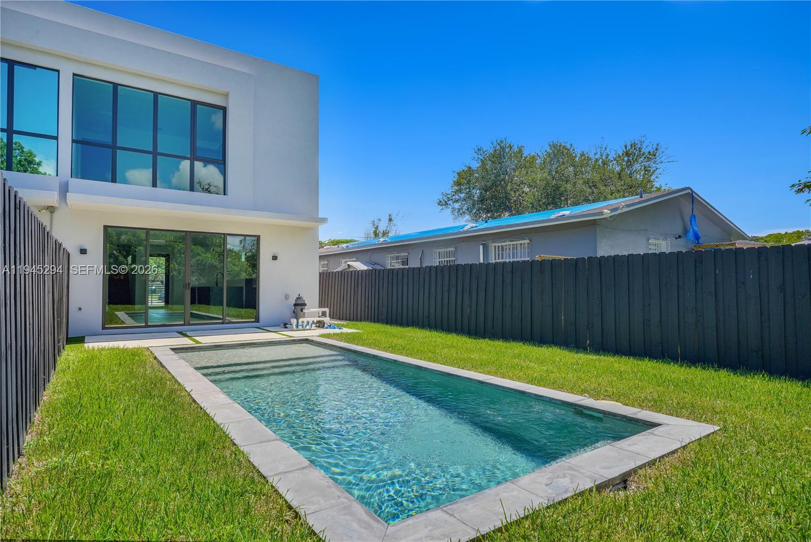 355 Northwest 50th Street Miami, FL 33127 - Photo 8 of 25 a view of a backyard with a swimming pool