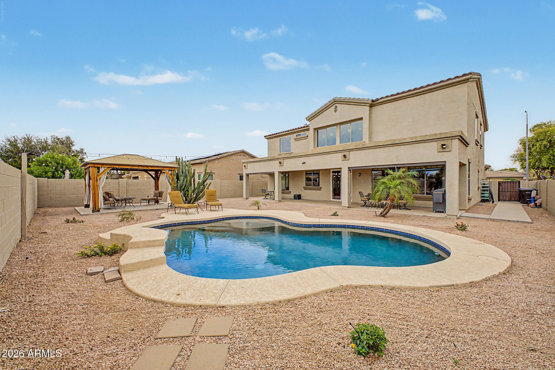 6580 South Agate Way Chandler, AZ 85249 - Photo 2 of 2 a view of a swimming pool with a lounge chair