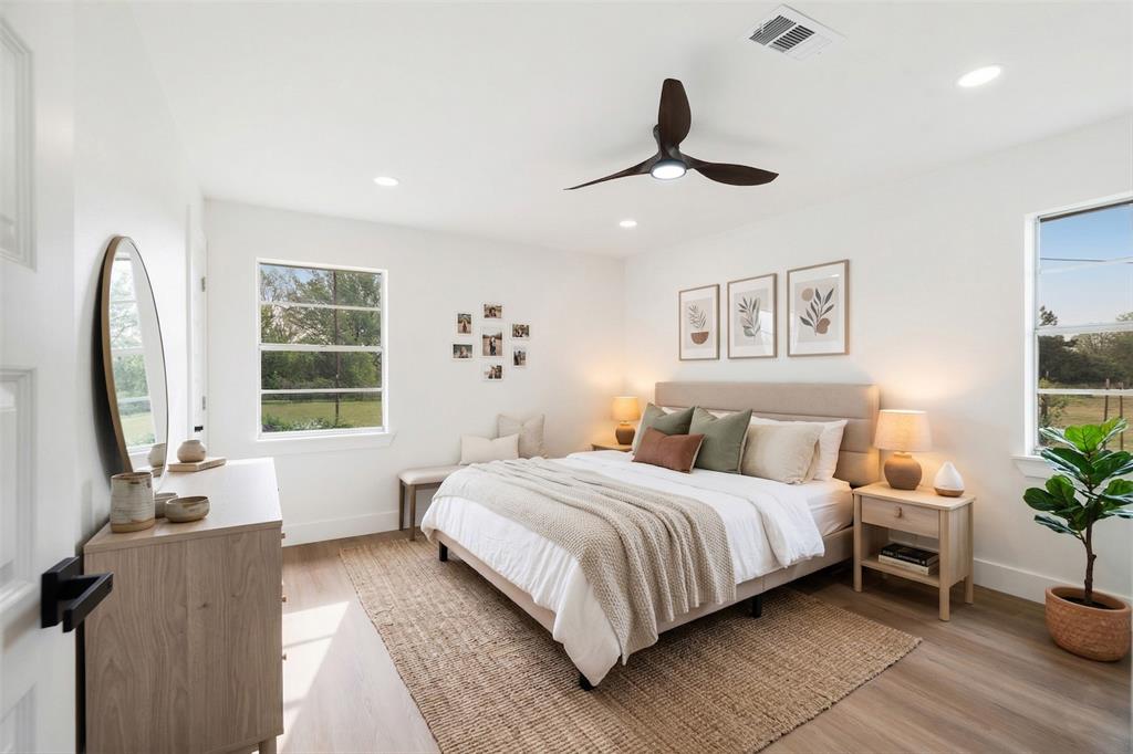 175 Cozy Lane Paris, TX 75462 - Photo 10 of 21 a bedroom with a large bed and a chandelier