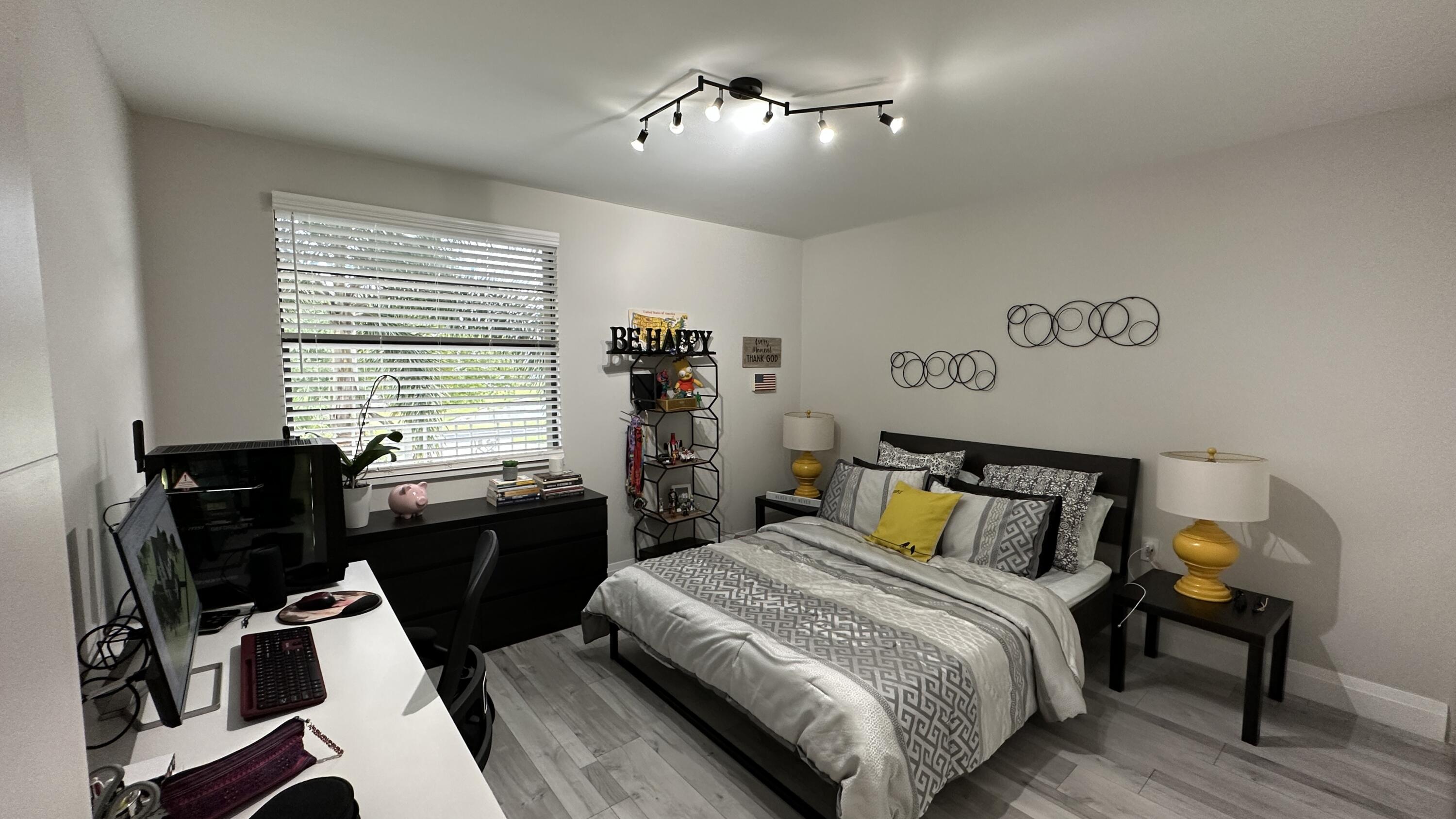 6073 Balboa Circle, Unit 305 Boca Raton, FL 33433 - Photo 11 of 29 a bedroom with a bed and a desk