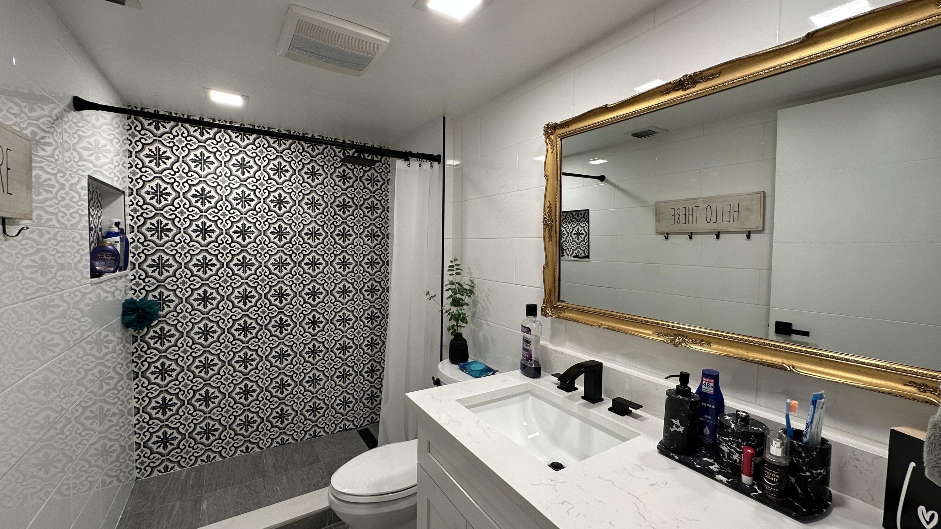 6073 Balboa Circle, Unit 305 Boca Raton, FL 33433 - Photo 13 of 29 a bathroom with a sink toilet and shower