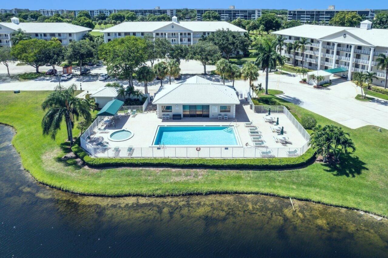 6073 Balboa Circle, Unit 305 Boca Raton, FL 33433 - Photo 24 of 29 a view of a swimming pool with a patio and plants