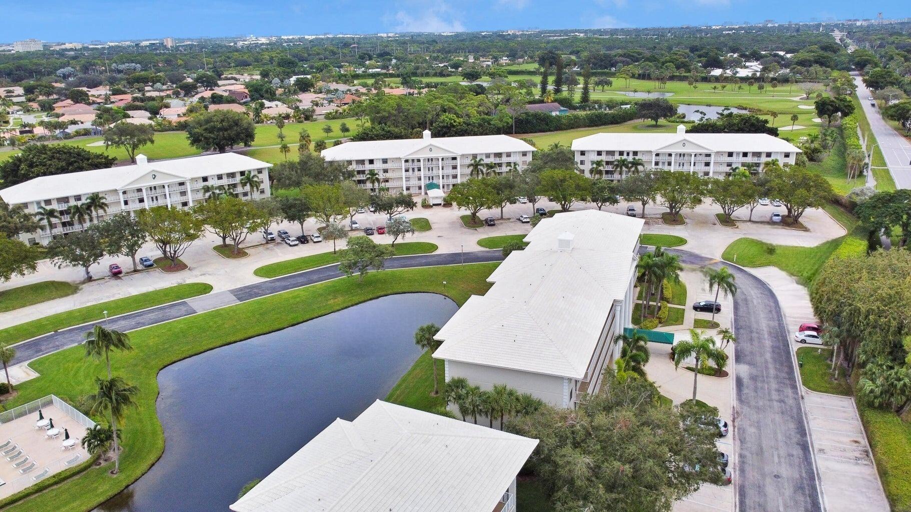 6073 Balboa Circle, Unit 305 Boca Raton, FL 33433 - Photo 28 of 29 an aerial view of a house with a garden and lake view