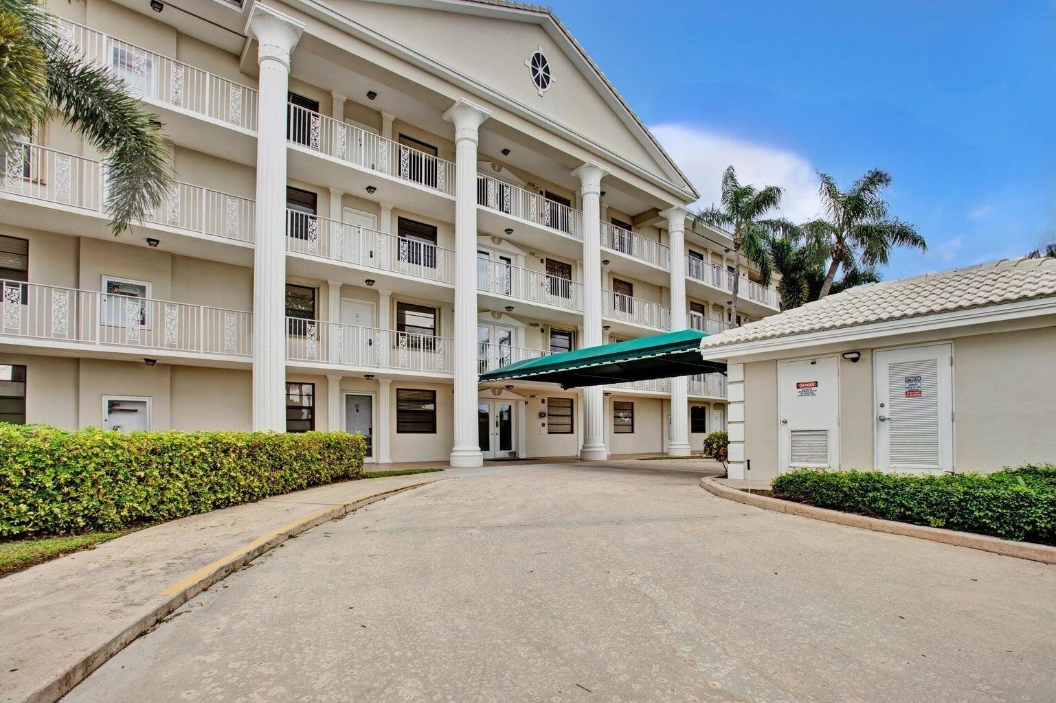 6073 Balboa Circle, Unit 305 Boca Raton, FL 33433 - Photo 29 of 29 a front view of a building with a street