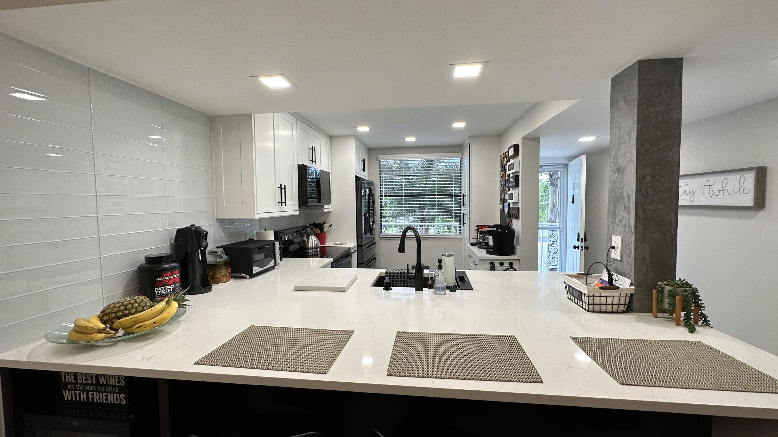 6073 Balboa Circle, Unit 305 Boca Raton, FL 33433 - Photo 4 of 29 a view of a dining room with a table and chairs