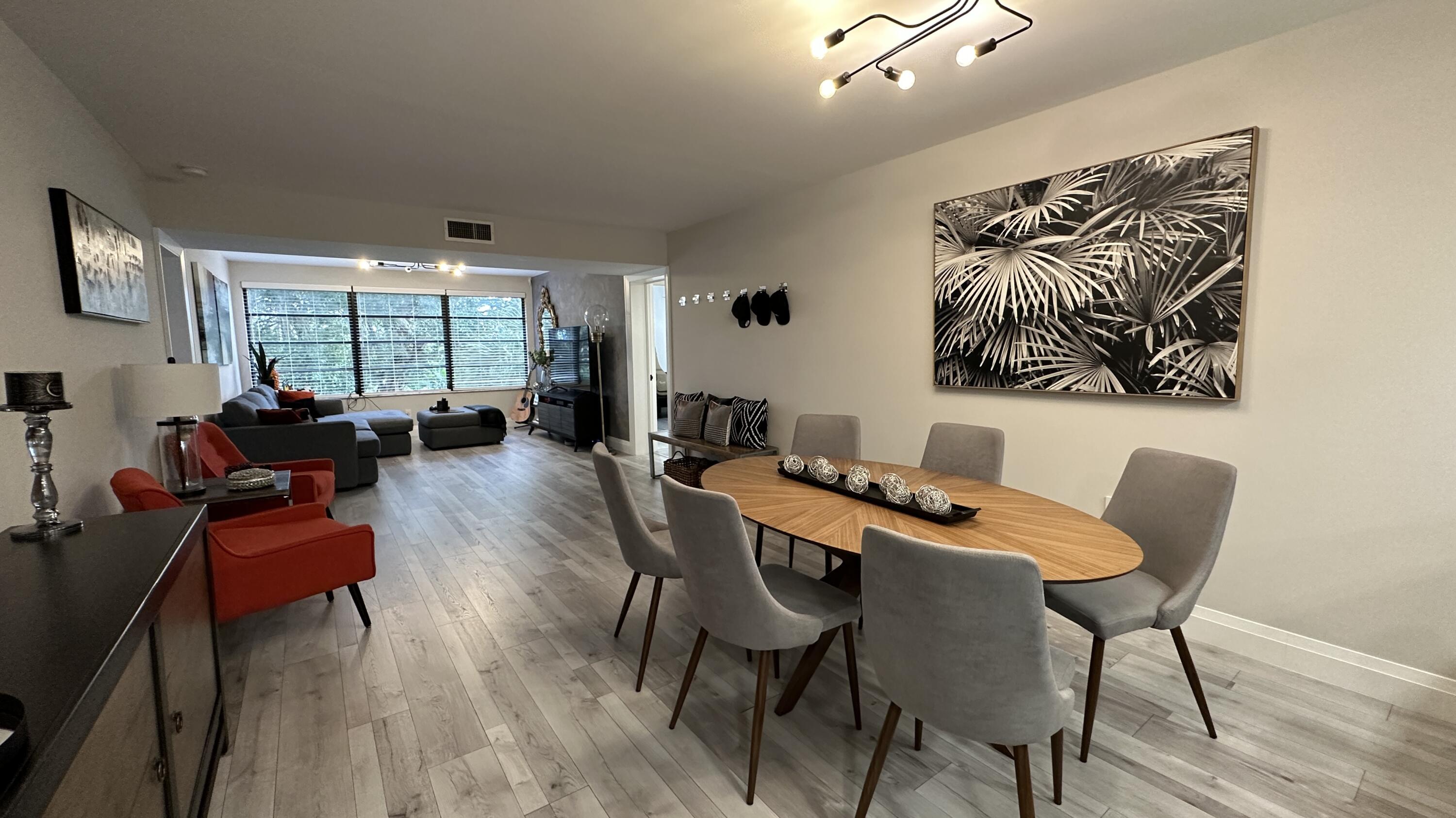 6073 Balboa Circle, Unit 305 Boca Raton, FL 33433 - Photo 8 of 29 a view of a dining room with furniture window and wooden floor