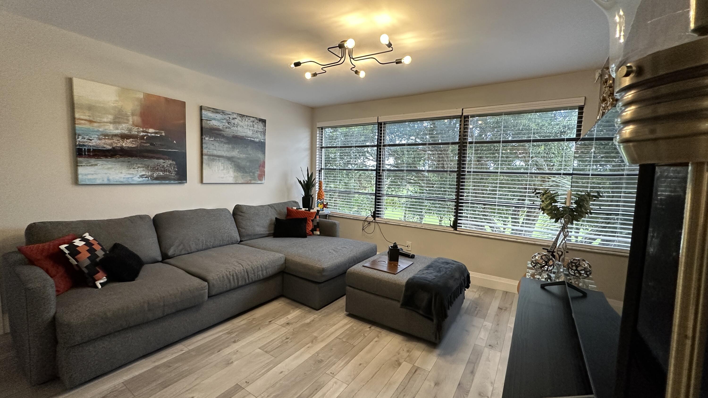6073 Balboa Circle, Unit 305 Boca Raton, FL 33433 - Photo 9 of 29 a living room with furniture and a large window