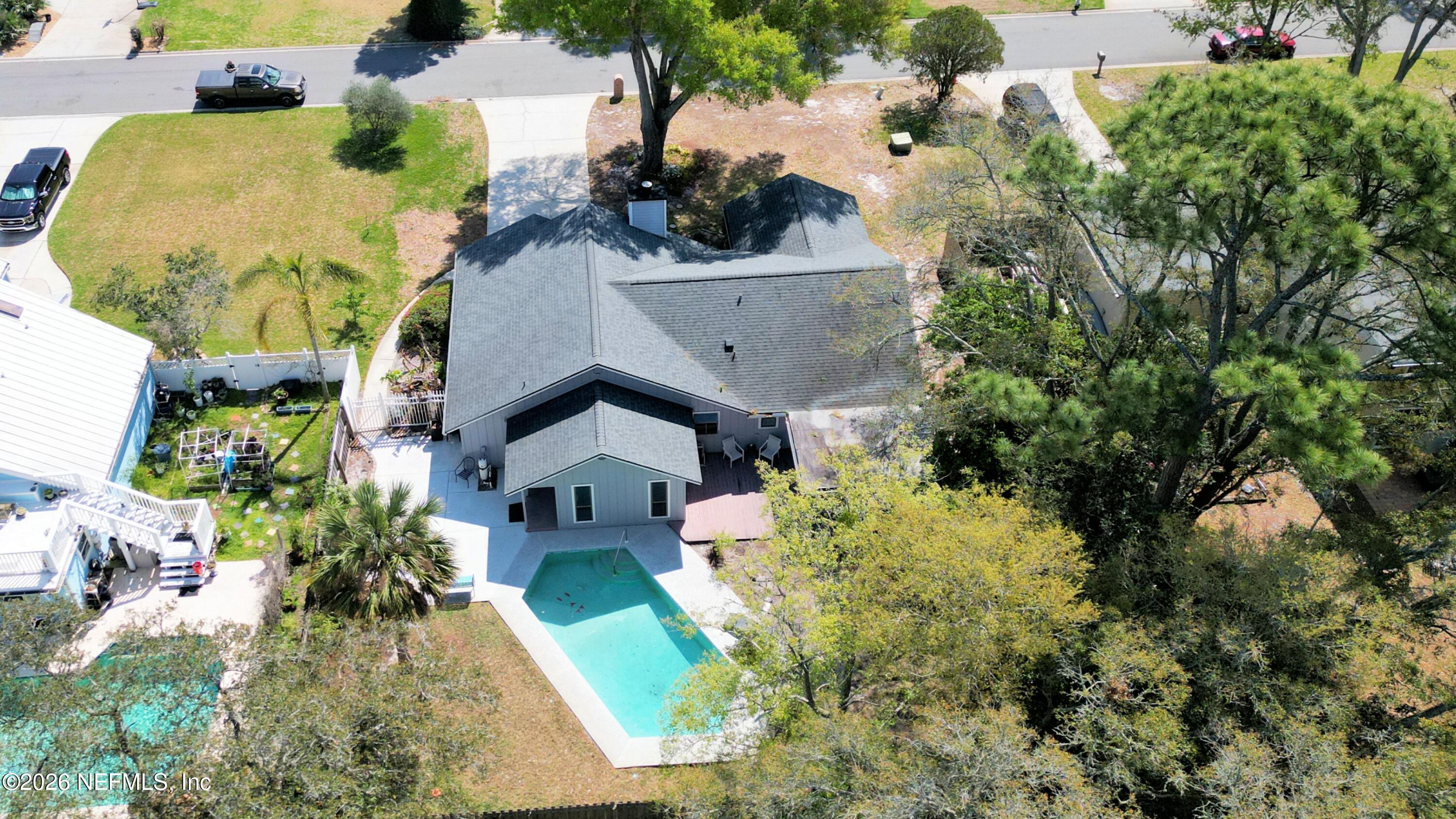 1074 Kings Road Neptune Beach, FL 32266 - Photo 23 of 31 an aerial view of a house with swimming pool and large trees