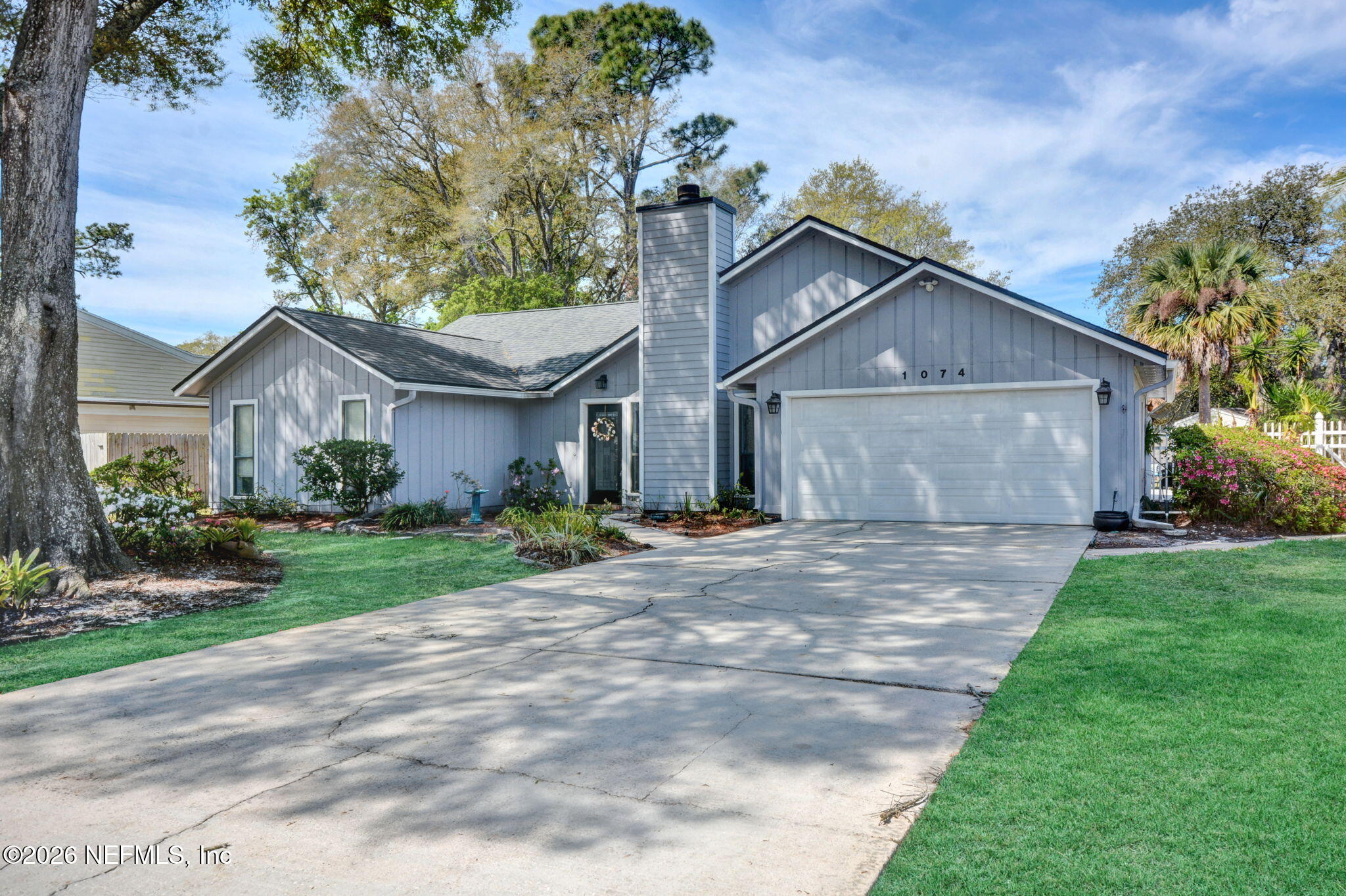 1074 Kings Road Neptune Beach, FL 32266 - Photo 3 of 31 a front view of a house with a garden and yard