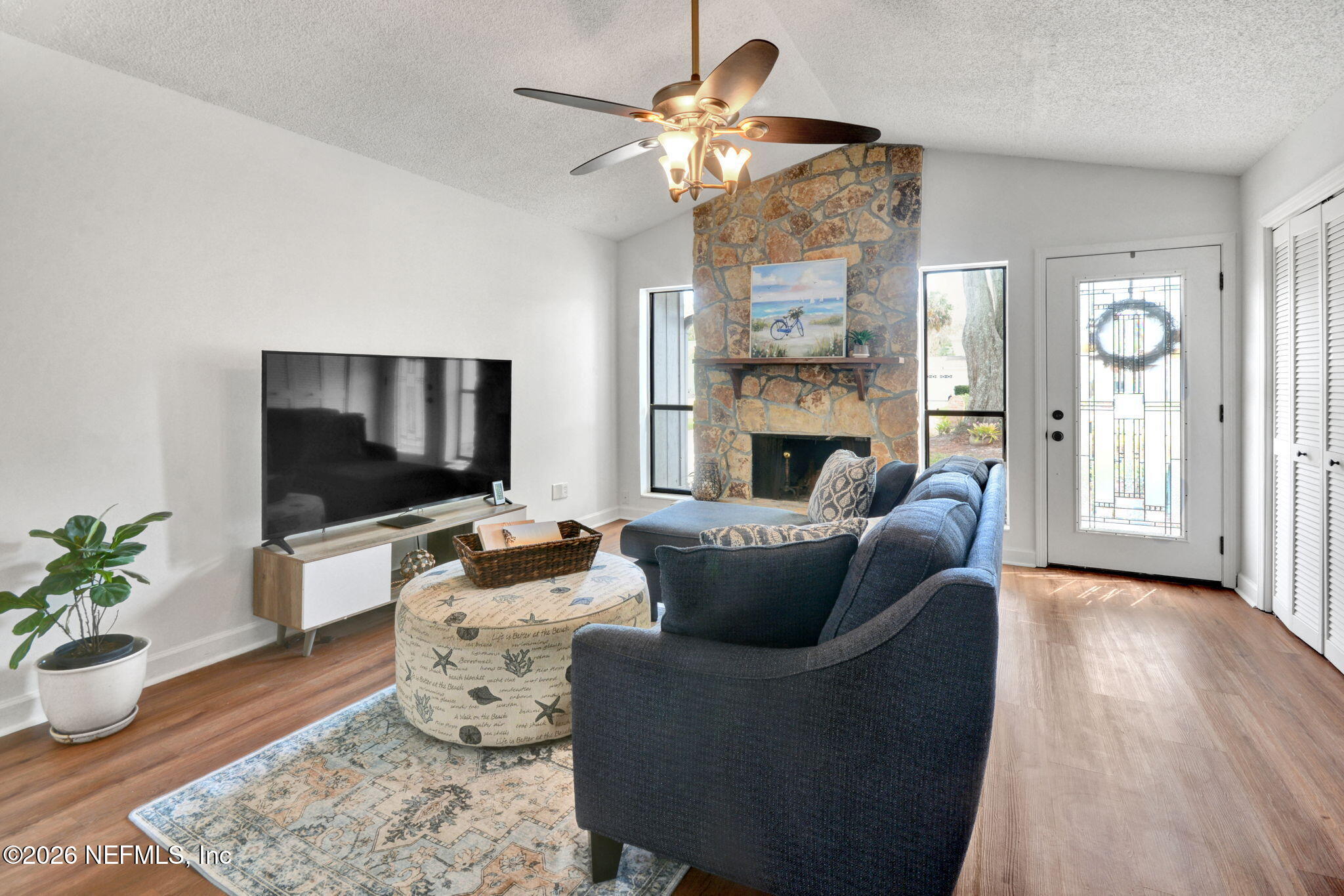 1074 Kings Road Neptune Beach, FL 32266 - Photo 6 of 31 a living room with furniture wooden floor and a flat screen tv