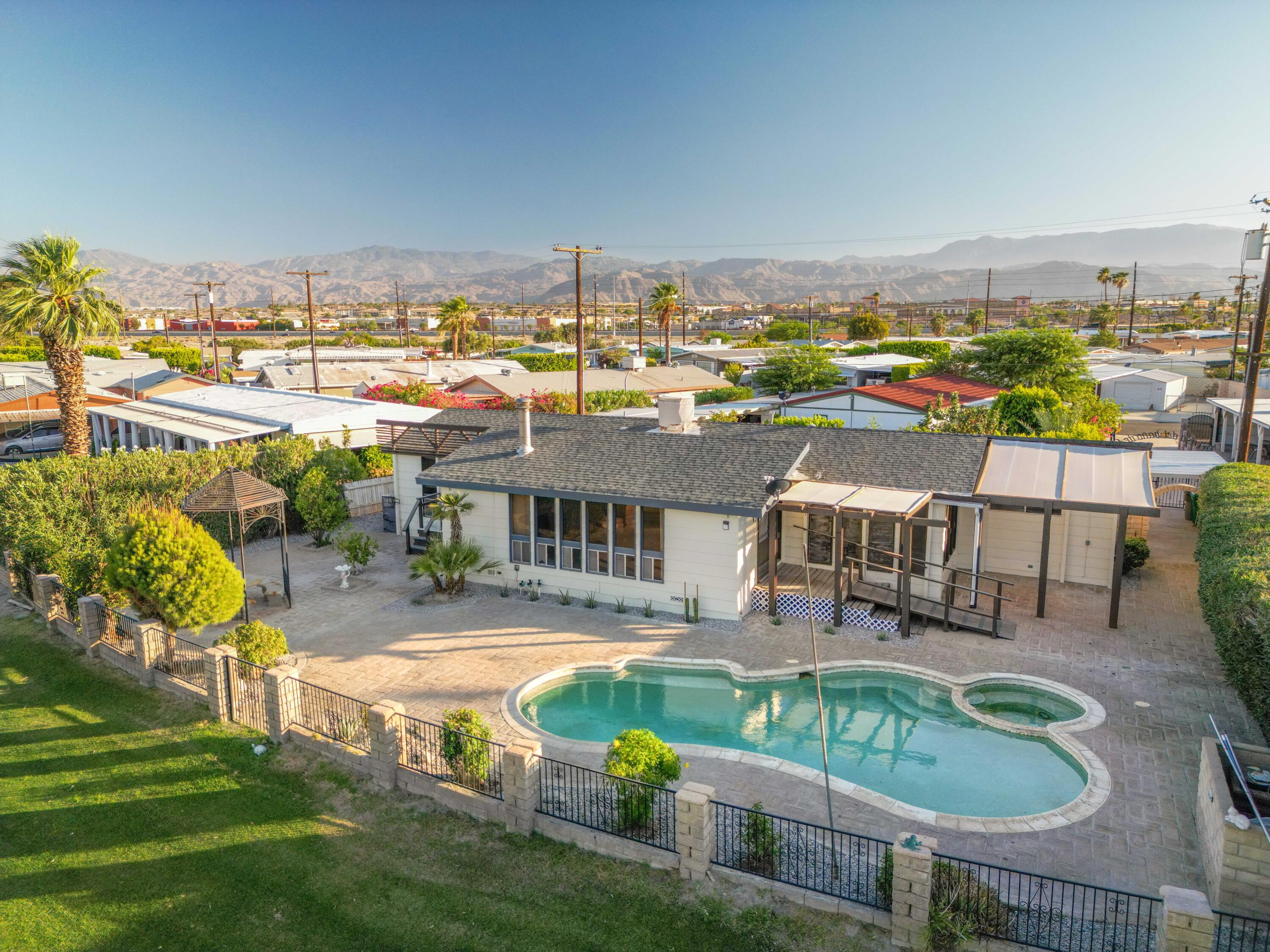 33440 Carlsbad Circle Thousand Palms, CA 92276 - Photo 1 of 52 a view of a swimming pool with lawn chairs and a yard