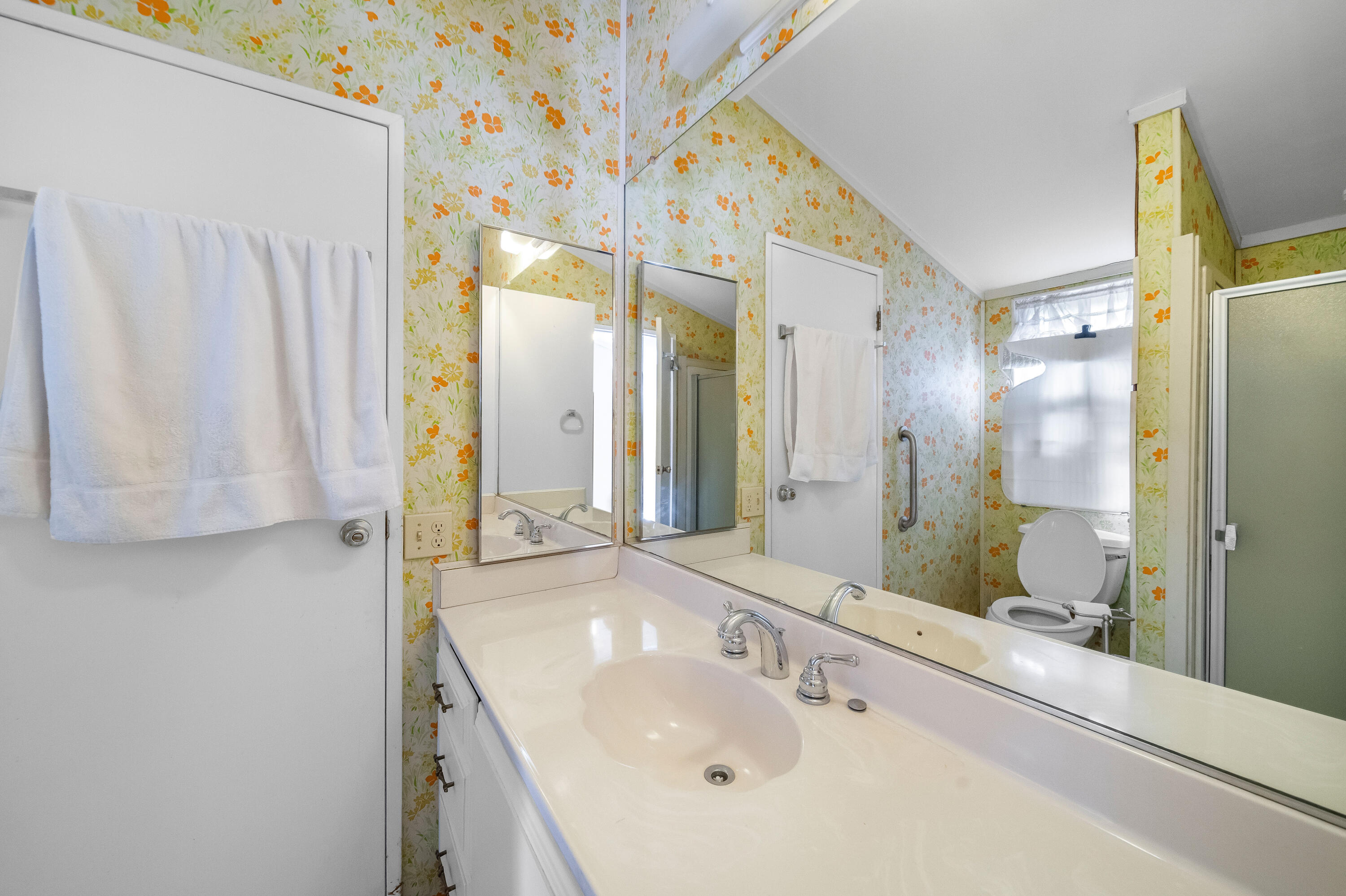 33440 Carlsbad Circle Thousand Palms, CA 92276 - Photo 12 of 52 a bathroom with a double vanity sink and a mirror