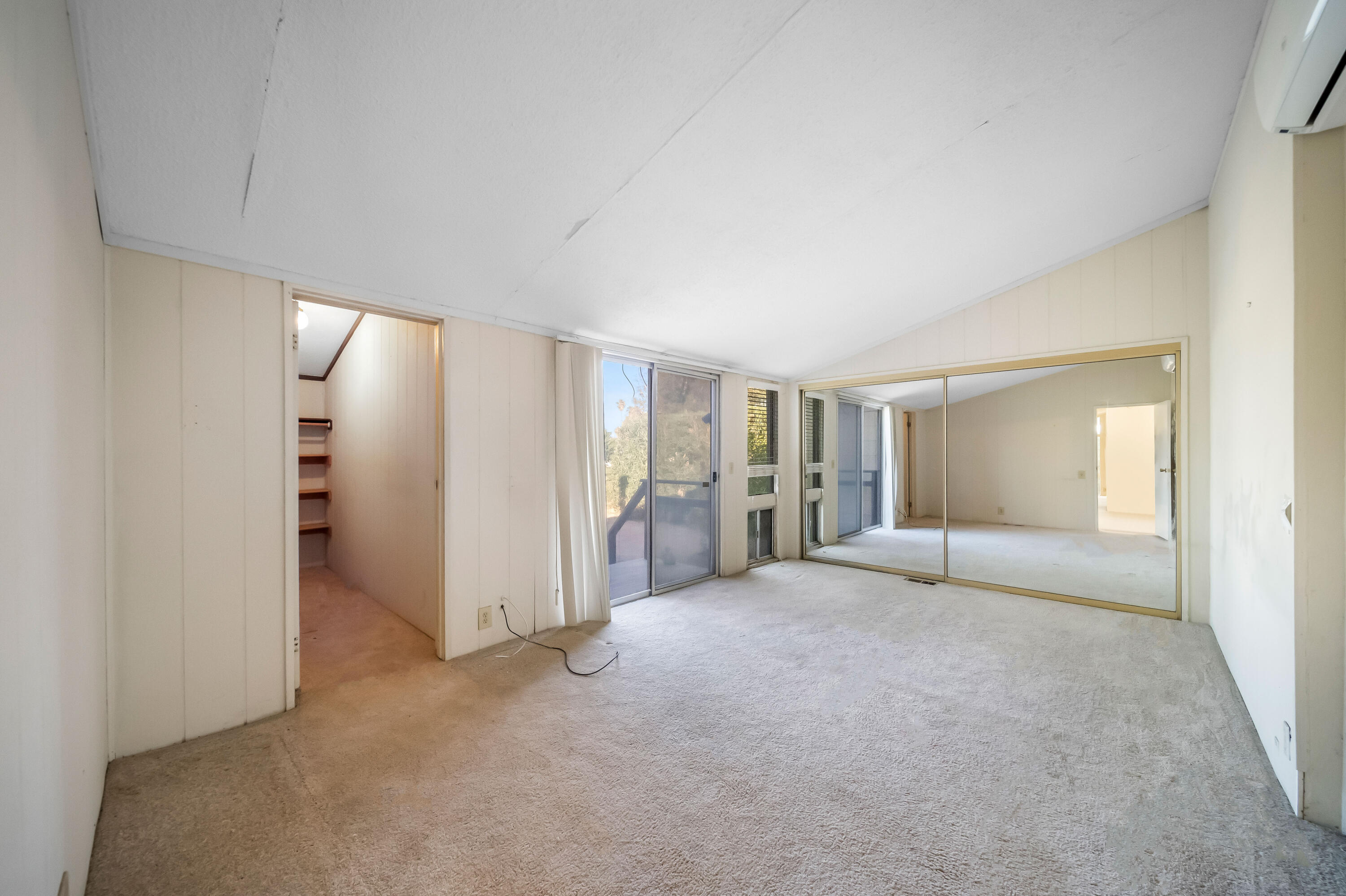33440 Carlsbad Circle Thousand Palms, CA 92276 - Photo 21 of 52 an empty room with a cabinet and mirrors