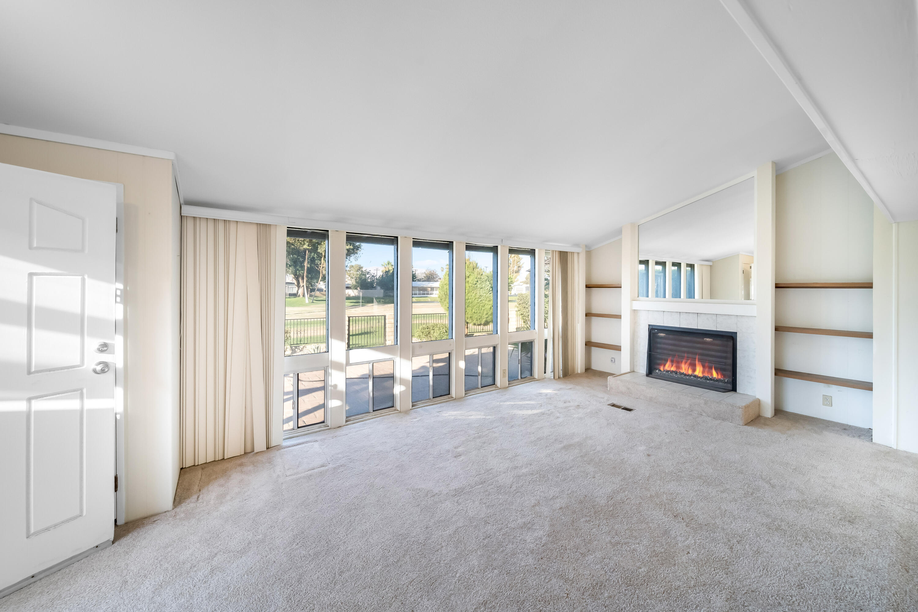 33440 Carlsbad Circle Thousand Palms, CA 92276 - Photo 3 of 52 an empty room with furniture and a fireplace