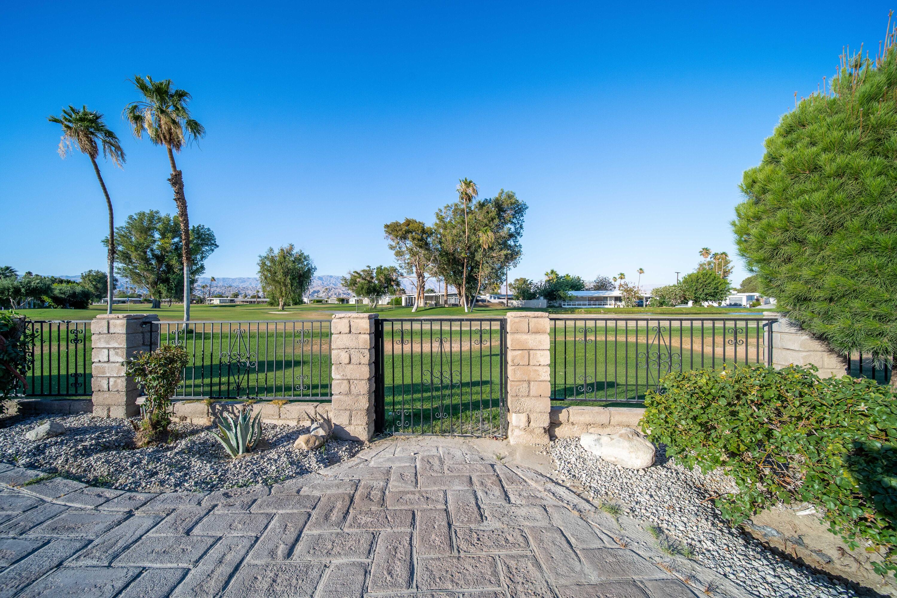 33440 Carlsbad Circle Thousand Palms, CA 92276 - Photo 33 of 52 a view of a deck with a bench and trees around