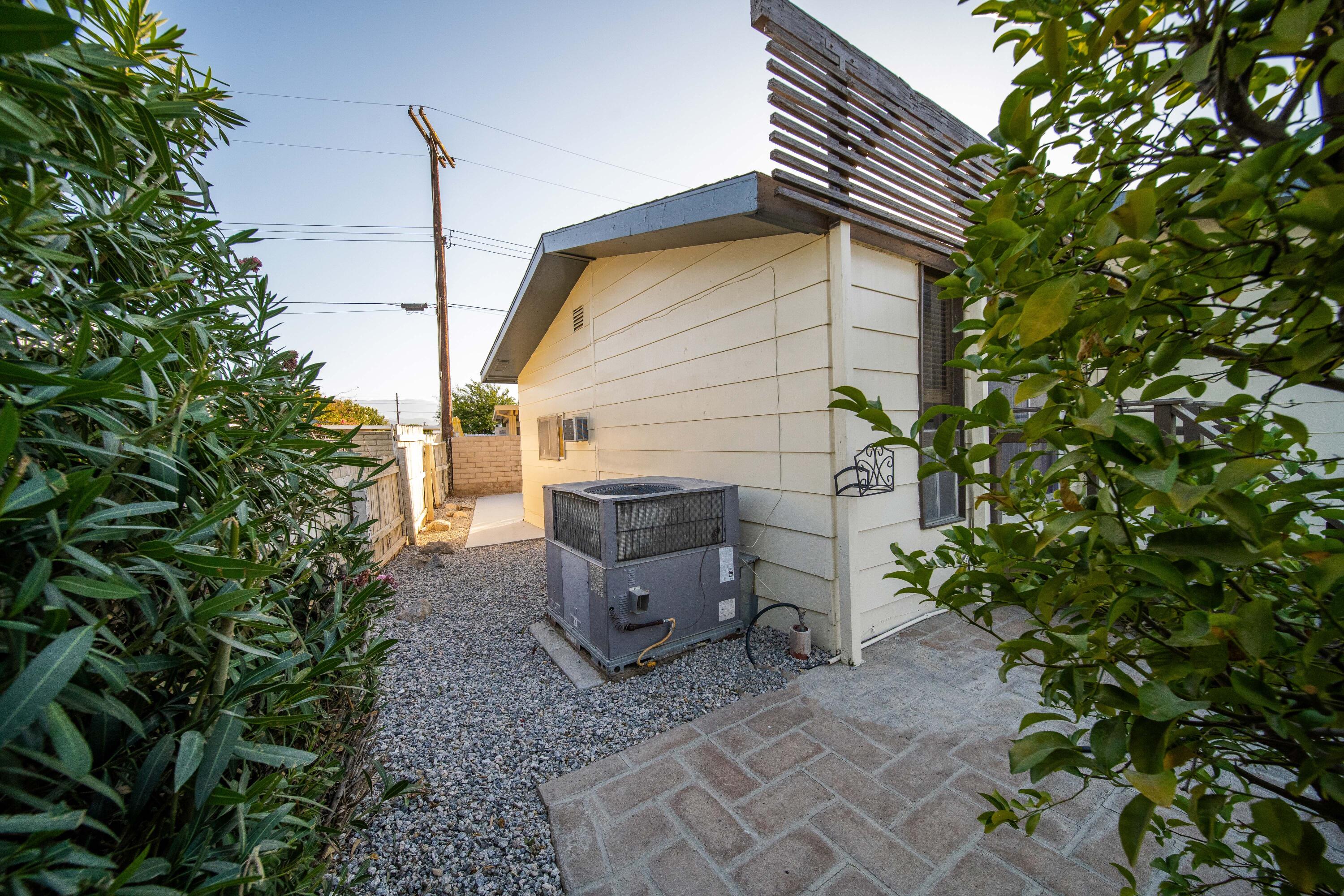 33440 Carlsbad Circle Thousand Palms, CA 92276 - Photo 40 of 52 a backyard of a house with plants and entertaining space