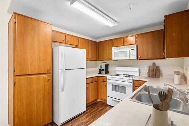 a kitchen with a refrigerator a sink and cabinets