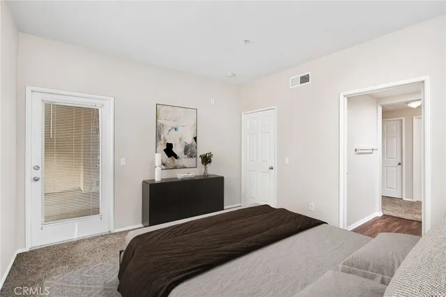 a bedroom with a bed and a mirror