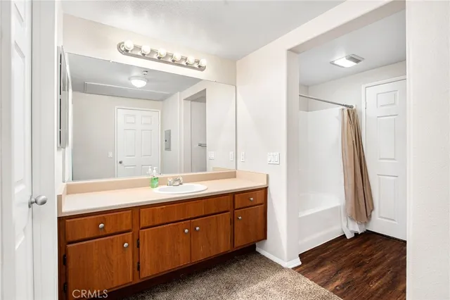 a bathroom with a double vanity sink and mirror with shower