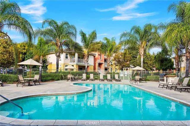 a swimming pool with outdoor seating and yard