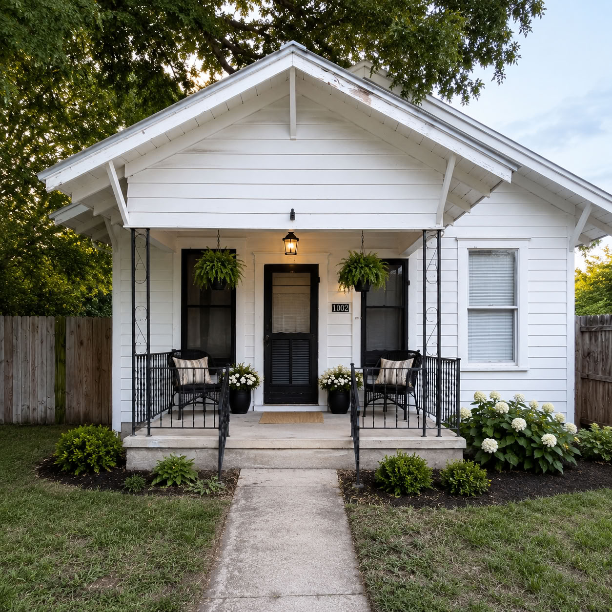 1002 Washburn Street Taylor, TX 76574 - Photo 1 of 29 A charming cottage facade with a welcoming porch and meticulous landscaping beckons.