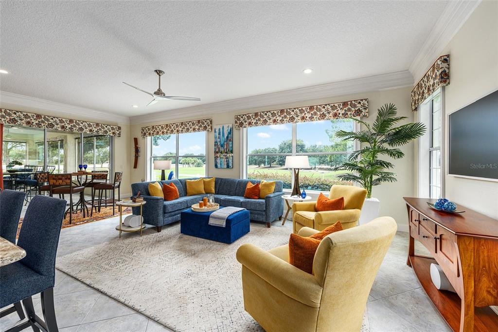 8671 Southwest 83rd Loop Ocala, FL 34481 - Photo 24 of 58 a living room with fireplace furniture and a flat screen tv