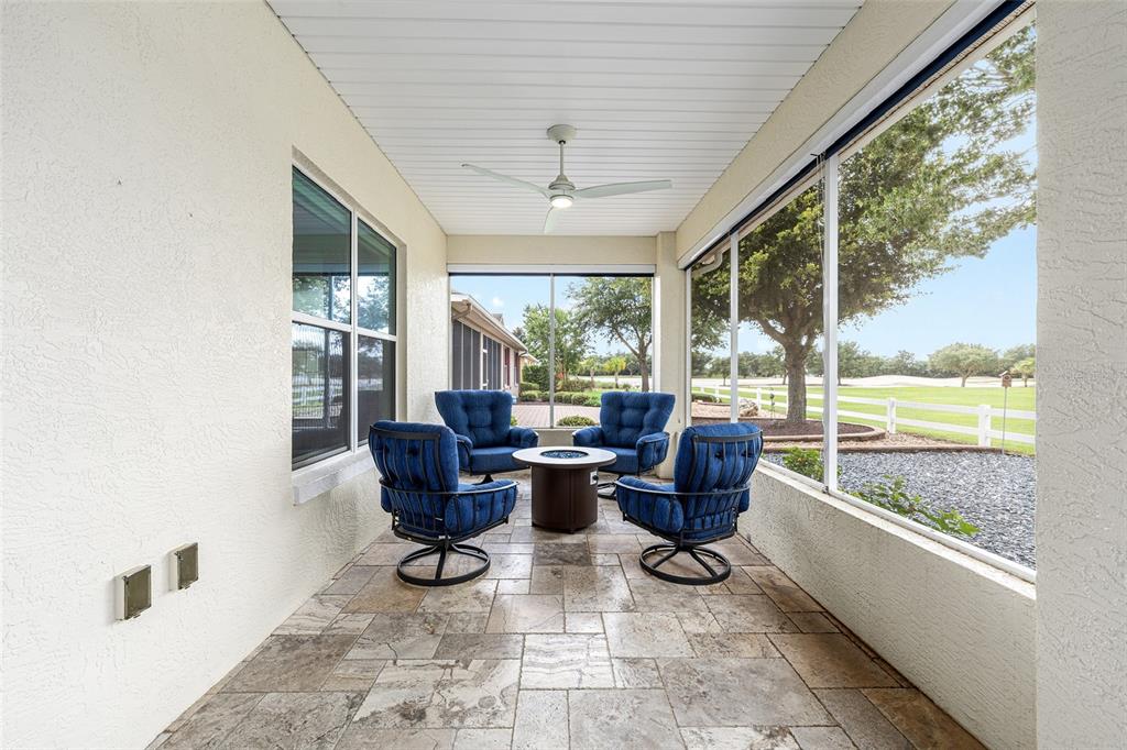 8671 Southwest 83rd Loop Ocala, FL 34481 - Photo 30 of 58 a living room with furniture and floor to ceiling windows