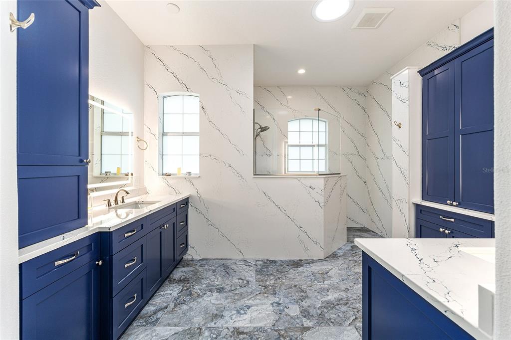 8671 Southwest 83rd Loop Ocala, FL 34481 - Photo 36 of 58 a spacious bathroom with a granite countertop sink mirror and a