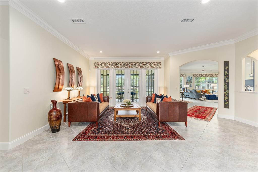 8671 Southwest 83rd Loop Ocala, FL 34481 - Photo 6 of 58 a living room with furniture a rug and a large window