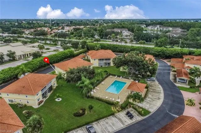 an aerial view of a house with a garden and lake view