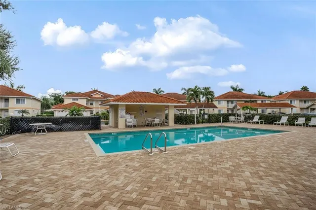 a view of a house with a yard and potted plants