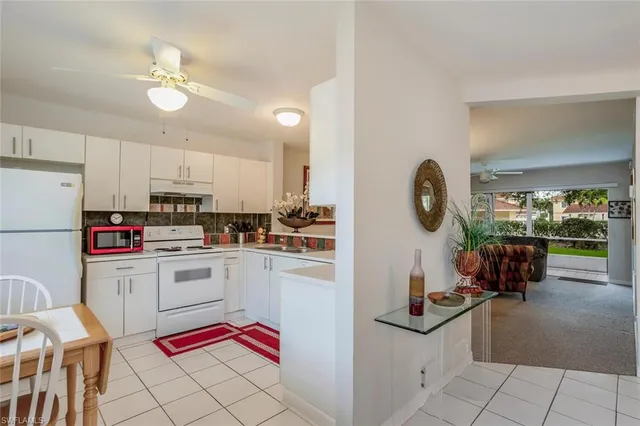a kitchen with stainless steel appliances a stove a refrigerator and cabinets