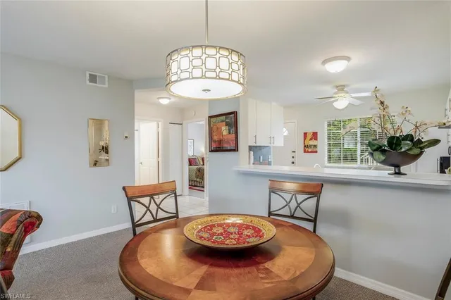 a dining room with furniture and window