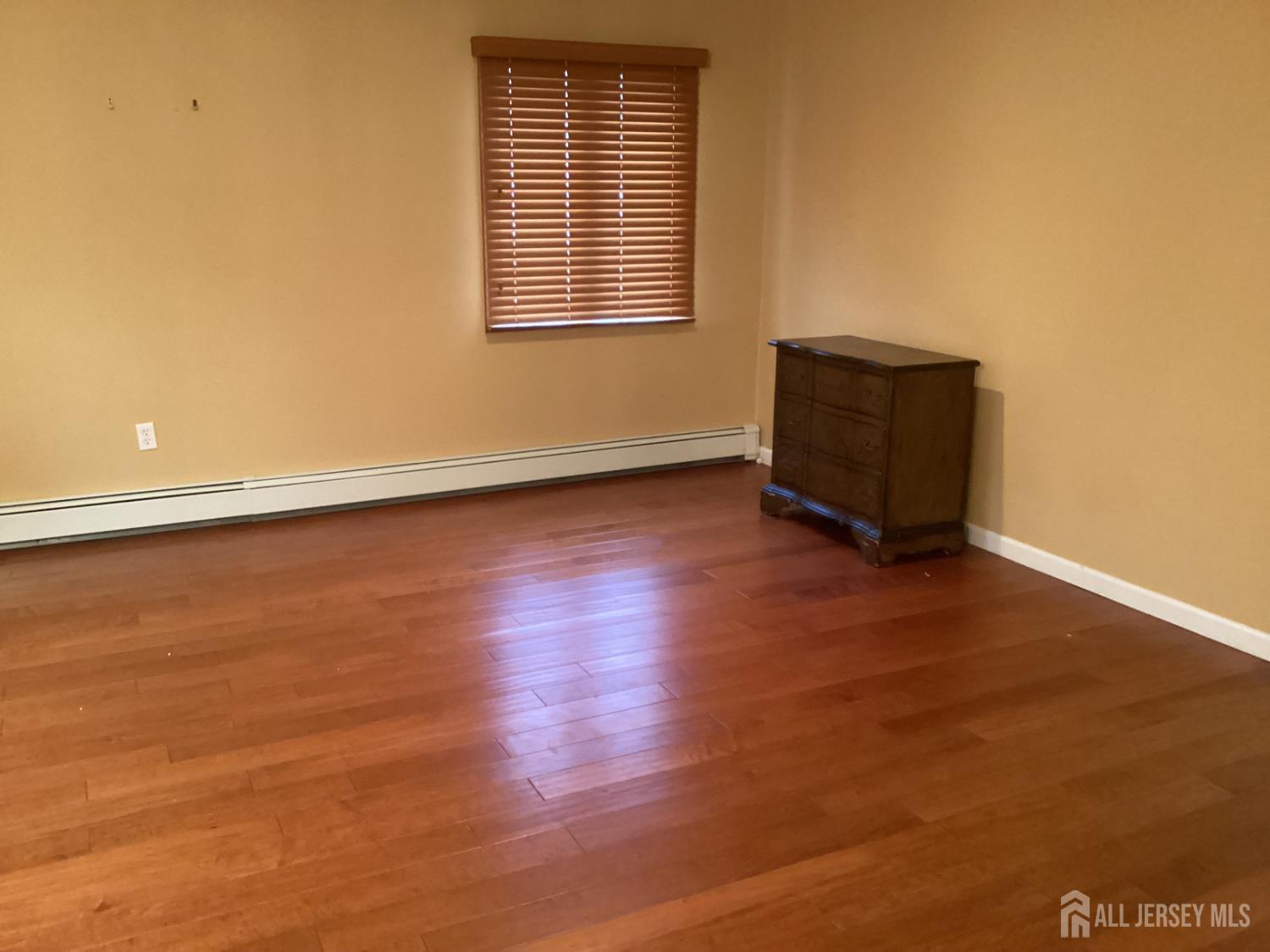 41 Faith Lane Matawan, NJ 07747 - Photo 12 of 24 an empty room with wooden floor and windows