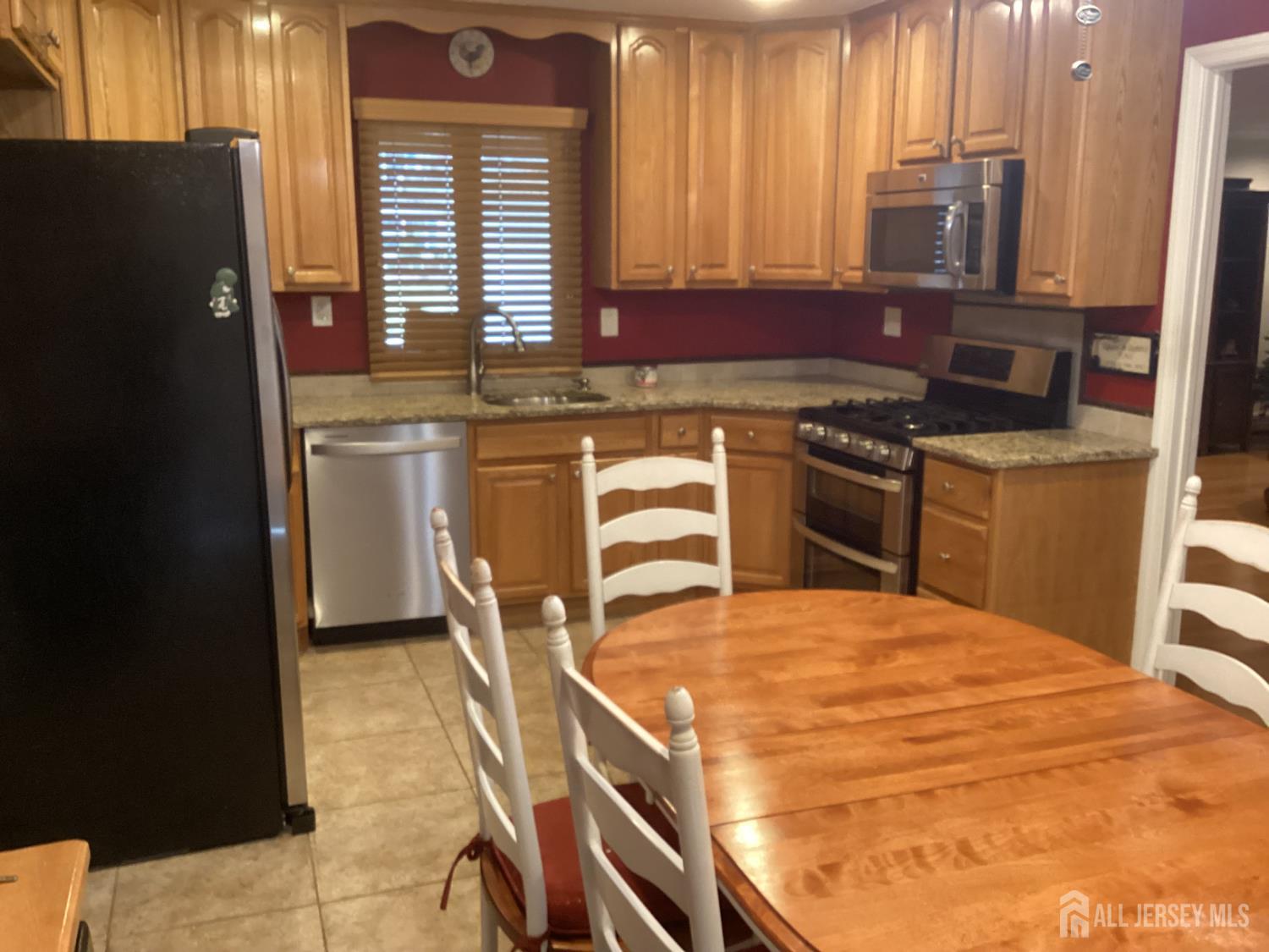 41 Faith Lane Matawan, NJ 07747 - Photo 16 of 24 a kitchen with stainless steel appliances granite countertop a stove a sink and a microwave
