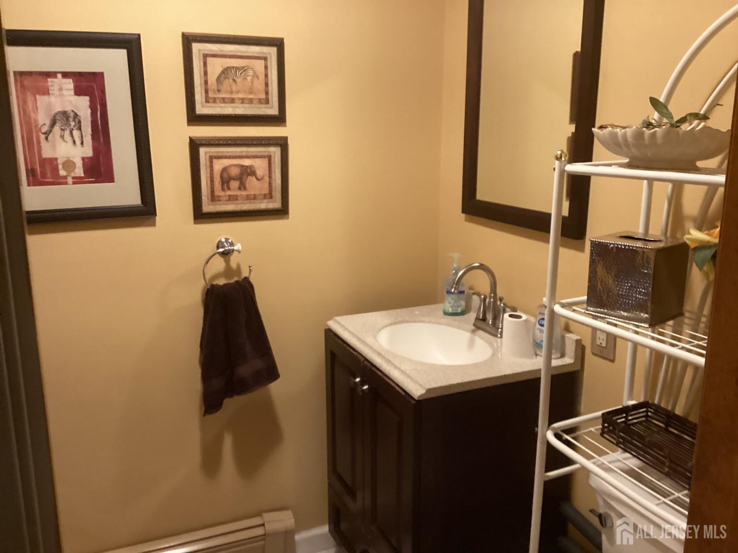 41 Faith Lane Matawan, NJ 07747 - Photo 18 of 24 a bathroom with a sink and a mirror