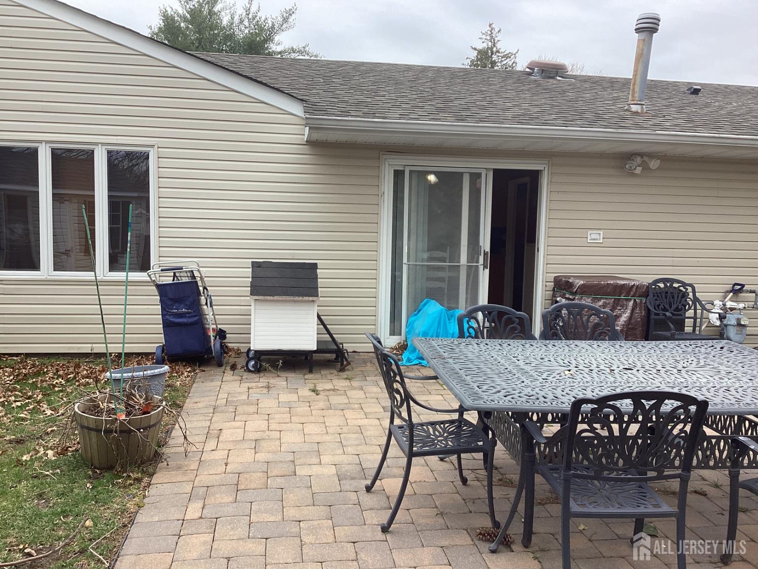 41 Faith Lane Matawan, NJ 07747 - Photo 9 of 24 a view of a patio with table and chairs and wooden fence