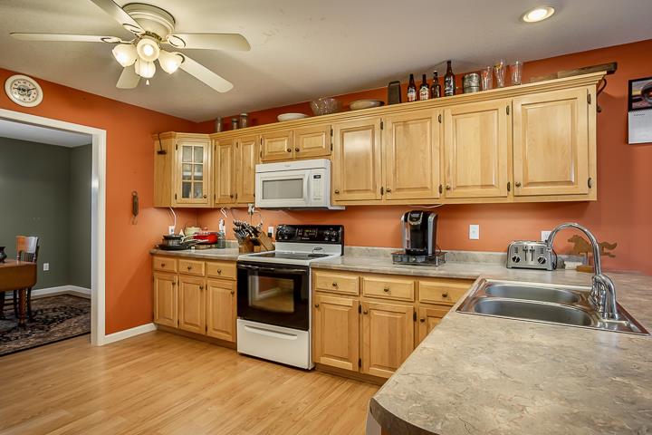 2329 Roslin Road Jamestown, TN 38556 - Photo 11 of 30 a kitchen with stainless steel appliances granite countertop a sink a stove cabinets and wooden floor