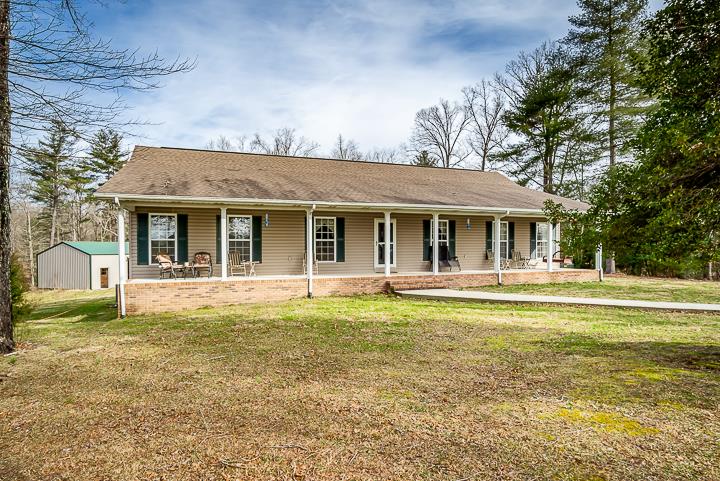 2329 Roslin Road Jamestown, TN 38556 - Photo 2 of 30 a front view of a house with swimming pool and porch with furniture