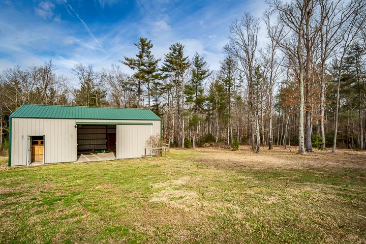 2329 Roslin Road Jamestown, TN 38556 - Photo 28 of 30 a front view of house with yard and trees in the background